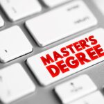 A close up of a computer key that says “master’s degree” instead of “enter.”