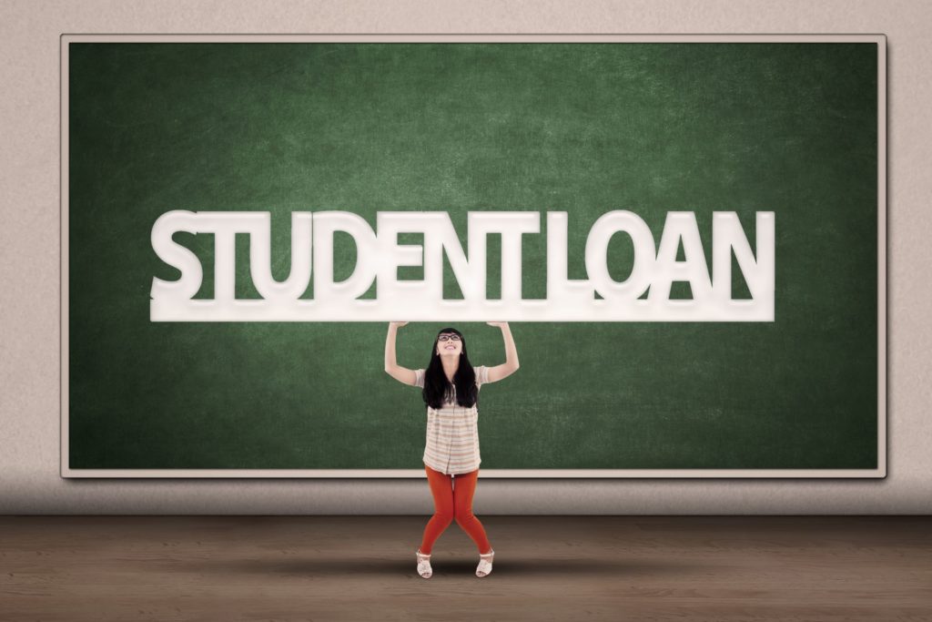 Women standing in front of chalkboard that says Student Loan