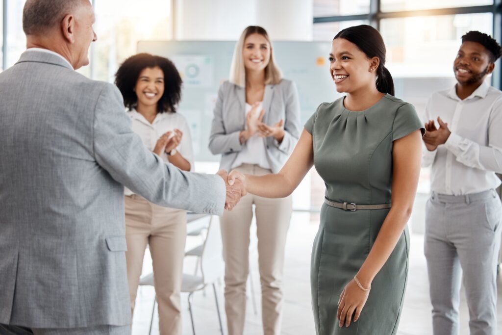 A supervisor shakes hand with a new hire during faculty onboarding.