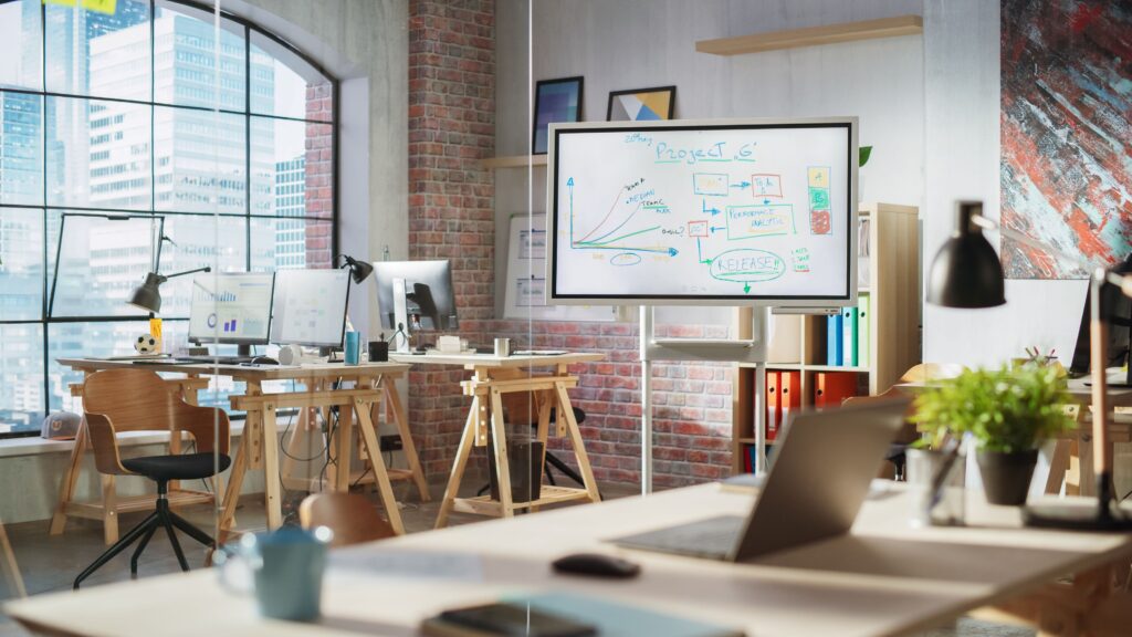 Close-up of a person writing on a virtual whiteboard like Figjam and Google Jamboard.