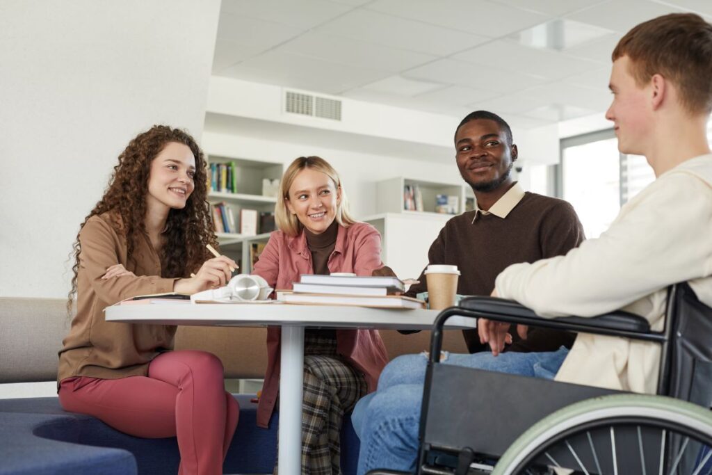 A diverse group of students works together on schoolwork.
