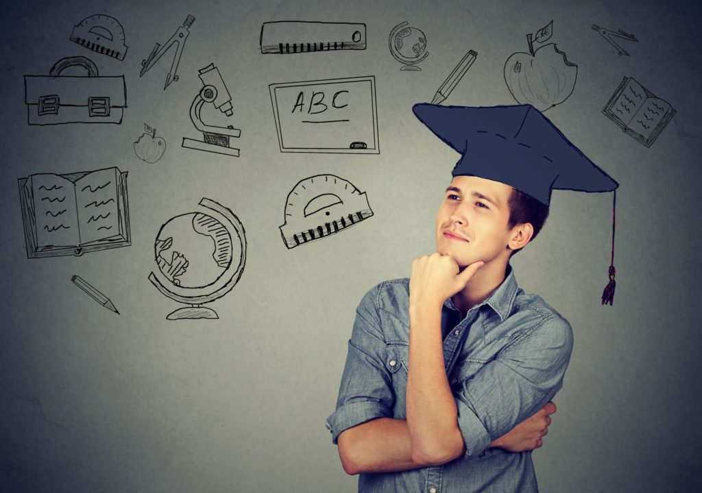 A man with a graduation cap on thinks about education..S. in Education