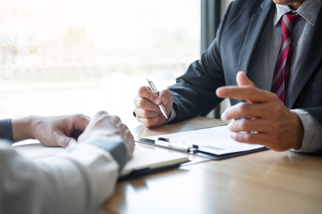 A interview reads through a resume; interviewee asks a question.
